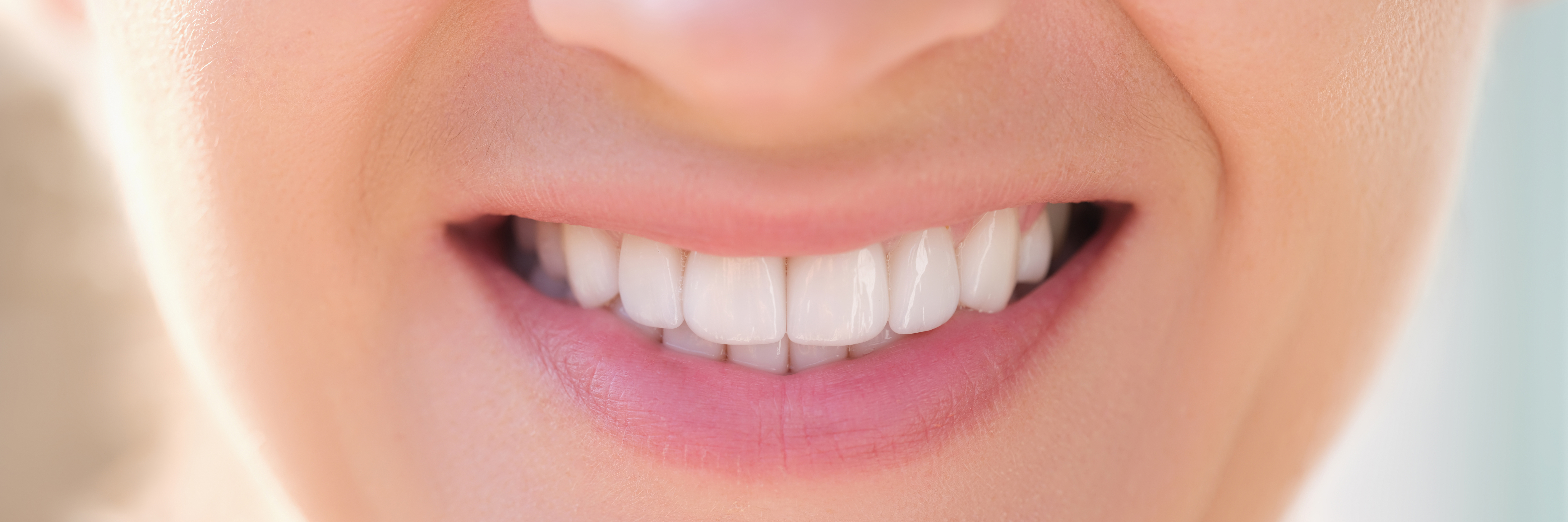 Close-up of happy smiling woman with perfect white teeth. Whitening teeth, dental care and stomatology concept